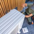 Experienced HVAC technician servicing an outdoor AC unit.